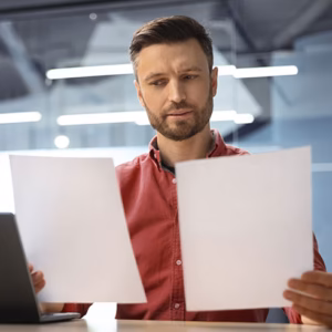 Man comparing documents