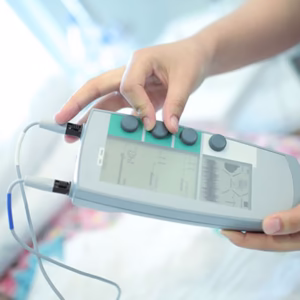 A nurse working with a portable medical device control