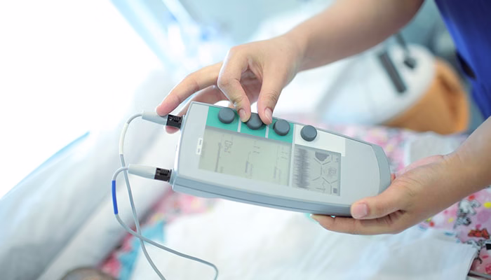A nurse working with a portable medical device control
