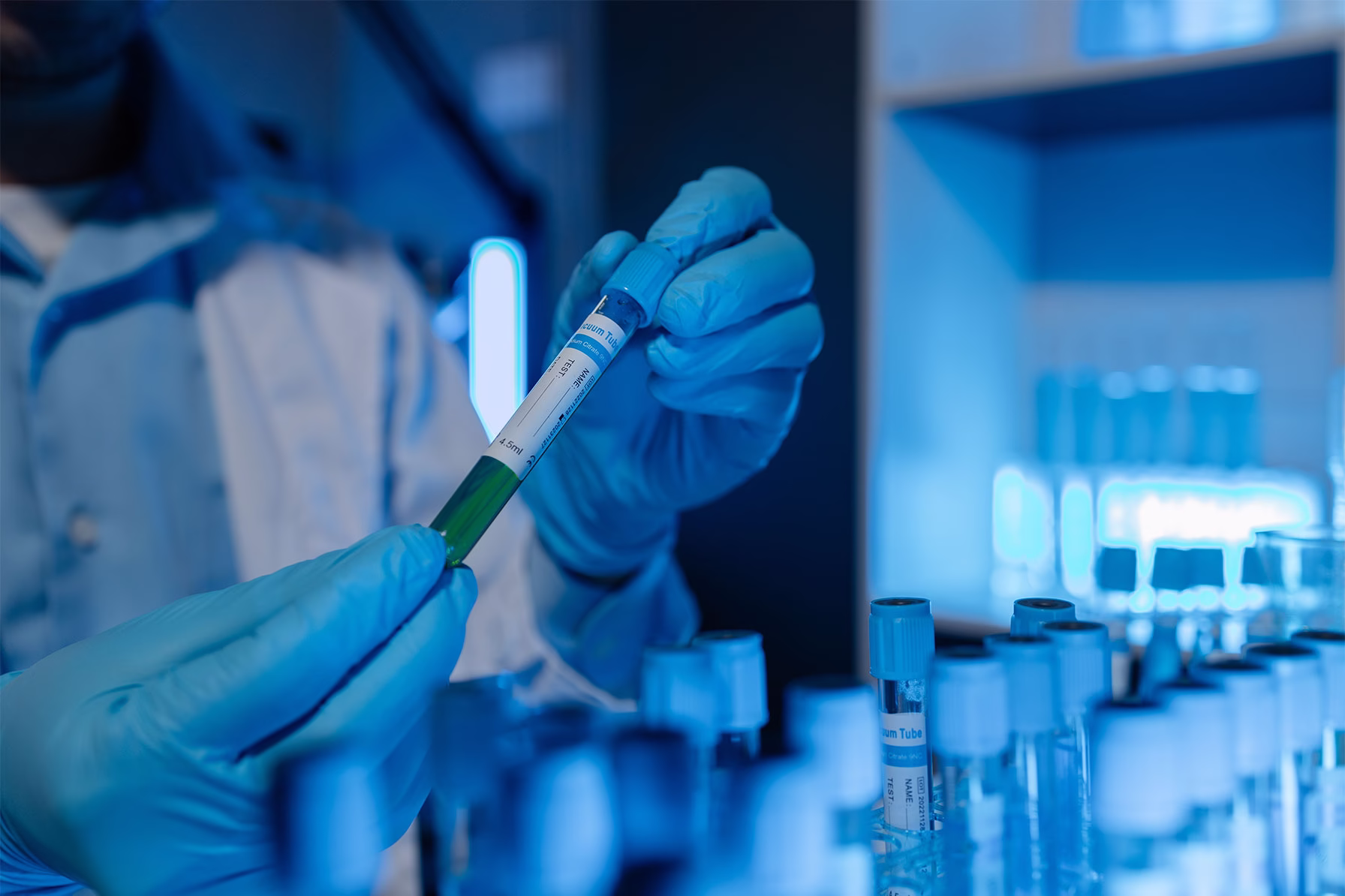 A lab technician handles a sample tube