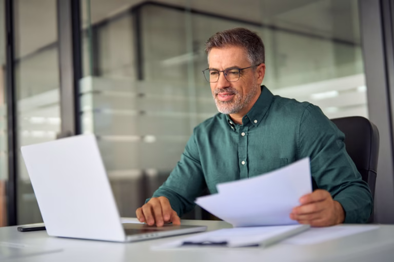 Man with laptop and documents